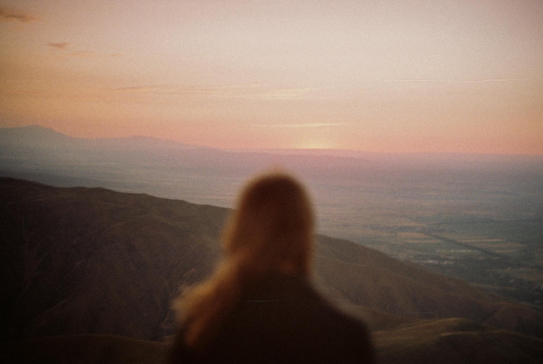 woman in a mountains having view on the sunrise